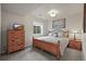 Bedroom with light gray walls, gray carpet, wooden bed frame, and a small window at 22485 Laurel Oak Dr, Parker, CO 80138