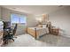 Bright bedroom with a wooden bed frame, gray carpet, a large window with expansive views, and a desk at 22485 Laurel Oak Dr, Parker, CO 80138