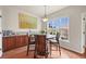 Sunlit breakfast nook featuring a round table, wood floors, and bright windows overlooking the outdoor scenery at 22485 Laurel Oak Dr, Parker, CO 80138