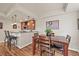 Dining area with hardwood floors, adjacent bar with pendant lighting, and a four-chair dining set at 22485 Laurel Oak Dr, Parker, CO 80138