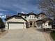 Stunning stucco and stone two-story home with a three-car garage and circular driveway at 22485 Laurel Oak Dr, Parker, CO 80138