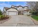 Beautiful stucco house with three-car garage, circular drive and stone accents at 22485 Laurel Oak Dr, Parker, CO 80138