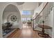 Inviting foyer with hardwood floors, staircase, arched doorways, and decorative wall art at 22485 Laurel Oak Dr, Parker, CO 80138