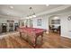 Game room with a billiards table, arcade game, and a view of the staircase and dining room at 22485 Laurel Oak Dr, Parker, CO 80138