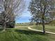 Lush green space view featuring a sidewalk lined with mature trees on a sunny day at 22485 Laurel Oak Dr, Parker, CO 80138