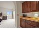 Hallway with wood cabinets that leads to a carpeted bedroom area with a view of the outside at 22485 Laurel Oak Dr, Parker, CO 80138