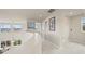 Hallway overlooking a living room with a curved railing and an artful painting on the wall at 22485 Laurel Oak Dr, Parker, CO 80138