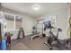 Well-equipped home gym with weight rack, bench press, exercise bike and rubber flooring at 22485 Laurel Oak Dr, Parker, CO 80138