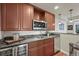 Kitchenette area with brown cabinets, granite counters, stainless steel appliances, and pendant lights at 22485 Laurel Oak Dr, Parker, CO 80138