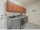 Laundry room featuring newer washer and dryer, utility sink, and wood cabinets at 22485 Laurel Oak Dr, Parker, CO 80138