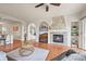 Spacious living room with stone fireplace, hardwood floors and ample natural light at 22485 Laurel Oak Dr, Parker, CO 80138
