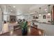 Living room with hardwood floors, stone fireplace, and views into the dining area and bar at 22485 Laurel Oak Dr, Parker, CO 80138