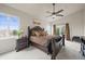 Spacious main bedroom featuring a ceiling fan, sliding glass doors to a deck, and a large bed at 22485 Laurel Oak Dr, Parker, CO 80138