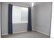 Bedroom with ample natural light from the window adorned with blue curtains at 4680 Copeland Loop # 203, Highlands Ranch, CO 80126