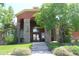Attractive building exterior featuring stone columns, arched entries, and lush landscaping at 4680 Copeland Loop # 203, Highlands Ranch, CO 80126