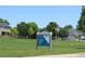 Community park with lush green grass, trees, and sign, creating a serene neighborhood environment at 4680 Copeland Loop # 203, Highlands Ranch, CO 80126