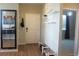 Inviting entryway with hardwood floors, showcasing the kitchen through a framed mirror at 4680 Copeland Loop # 203, Highlands Ranch, CO 80126