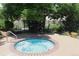 Inviting in-ground hot tub surrounded by lush landscaping and ample seating for relaxation at 4680 Copeland Loop # 203, Highlands Ranch, CO 80126