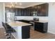 Bright eat-in kitchen features stainless steel appliances, dark cabinets, and center island with barstool seating at 4680 Copeland Loop # 203, Highlands Ranch, CO 80126