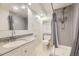 Bright bathroom with a walk-in shower, granite countertop vanity, and cabinet for storage at 5857 S Logan Ct, Centennial, CO 80121
