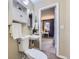 Charming powder room featuring tiled floors, modern fixtures, and entry to the bedroom at 5857 S Logan Ct, Centennial, CO 80121