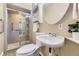 Updated bathroom with glass enclosed shower, and a modern toilet and sink at 5857 S Logan Ct, Centennial, CO 80121