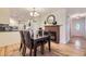 Open dining area with hardwood floors, fireplace, and seamless connection to the kitchen at 5857 S Logan Ct, Centennial, CO 80121