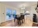 Bright dining area with French doors, hardwood floors, and easy access to the kitchen at 5857 S Logan Ct, Centennial, CO 80121