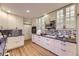 Kitchen featuring white cabinets, stainless steel appliances and stone countertops at 5857 S Logan Ct, Centennial, CO 80121