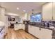 Bright kitchen featuring white cabinets, stone countertops and stainless steel appliances at 5857 S Logan Ct, Centennial, CO 80121