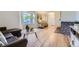 Cozy living room featuring hardwood floors, bay window, and stylish decor at 5857 S Logan Ct, Centennial, CO 80121
