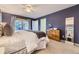 The spacious primary bedroom features plush carpet flooring, a ceiling fan, and access to the backyard at 5857 S Logan Ct, Centennial, CO 80121