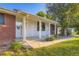 Inviting front porch with classic columns and a well-maintained garden in front at 5857 S Logan Ct, Centennial, CO 80121