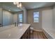 Bright bathroom with wood floor, a quartz countertop vanity, and a window offering scenic views at 16858 Greyhawk Dr, Monument, CO 80132