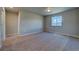 A bedroom with neutral carpet and walls, plus a window offering plenty of natural light and mountain views at 16858 Greyhawk Dr, Monument, CO 80132