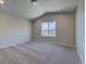 Bright bedroom with vaulted ceiling, neutral carpet, and a window with scenic views at 16858 Greyhawk Dr, Monument, CO 80132