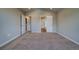 Large bedroom featuring neutral carpet and multiple doorways to other areas of the house at 16858 Greyhawk Dr, Monument, CO 80132