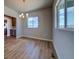Bright dining room featuring wood floors, a modern chandelier, and a large window with scenic views at 16858 Greyhawk Dr, Monument, CO 80132
