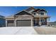 Charming two-story home featuring stone accents, a three-car garage, and a concrete driveway at 16858 Greyhawk Dr, Monument, CO 80132