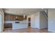 Bright kitchen with stainless steel appliances, granite counters, wooden cabinets, and hardwood floors at 16858 Greyhawk Dr, Monument, CO 80132