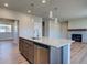 Open-concept kitchen featuring stainless steel appliances, a large island, and modern lighting fixtures at 16858 Greyhawk Dr, Monument, CO 80132