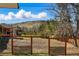 Fenced backyard with view of a hill beyond the trees at 13905 W 21St Ave, Golden, CO 80401