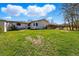 Large backyard with lawn and patio area on a sunny day, surrounded by a wooden fence at 13905 W 21St Ave, Golden, CO 80401