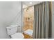 Bathroom features a shower with neutral tile and a toilet with modern fixtures at 13905 W 21St Ave, Golden, CO 80401