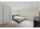 Bedroom with beige walls, a queen bed, a dark dresser, and a view out the window at 13905 W 21St Ave, Golden, CO 80401