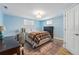 Bedroom with blue walls, a light fixture, a window, a desk, and a queen-size bed at 13905 W 21St Ave, Golden, CO 80401