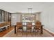 Light-filled dining room featuring wood floors, decorative lighting and a large window with a view at 13905 W 21St Ave, Golden, CO 80401