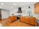 Open kitchen with wood cabinetry, granite countertops, and modern appliances and fixtures at 13905 W 21St Ave, Golden, CO 80401