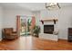Bright living room features hardwood floors, a brick fireplace, and sliding glass doors to the backyard at 13905 W 21St Ave, Golden, CO 80401