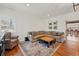Comfortable living room with hardwood floors, large sectional, and view into the dining area at 13905 W 21St Ave, Golden, CO 80401